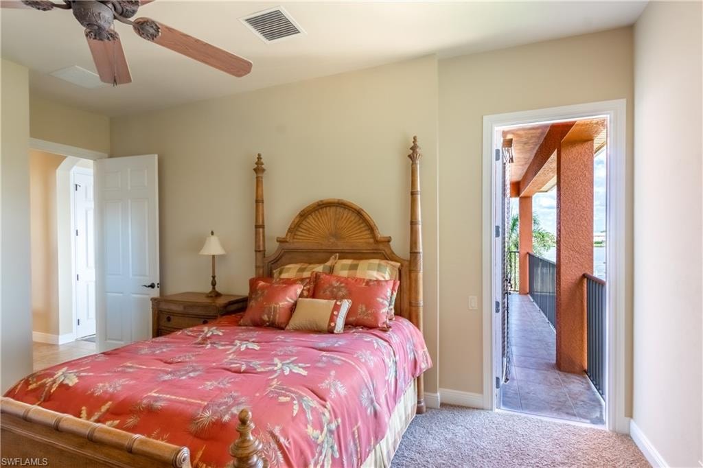 Bedroom featuring a ceiling fan, carpet flooring, and direct access to an exterior balcony with a railing