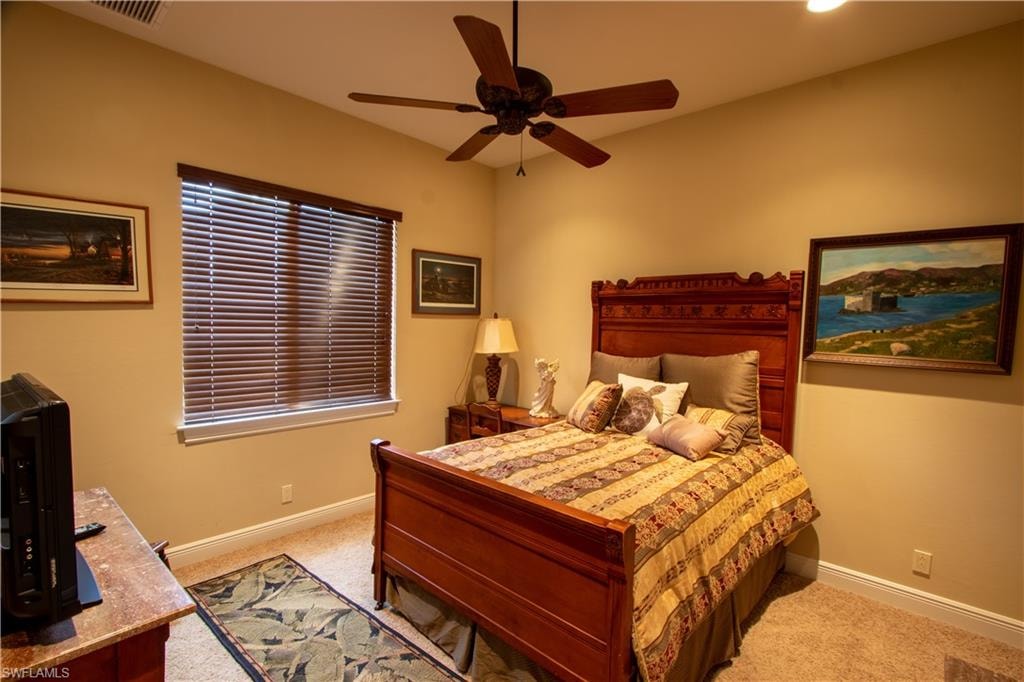 Carpeted room with a ceiling fan, recessed lighting, and a window featuring wood-finish blinds