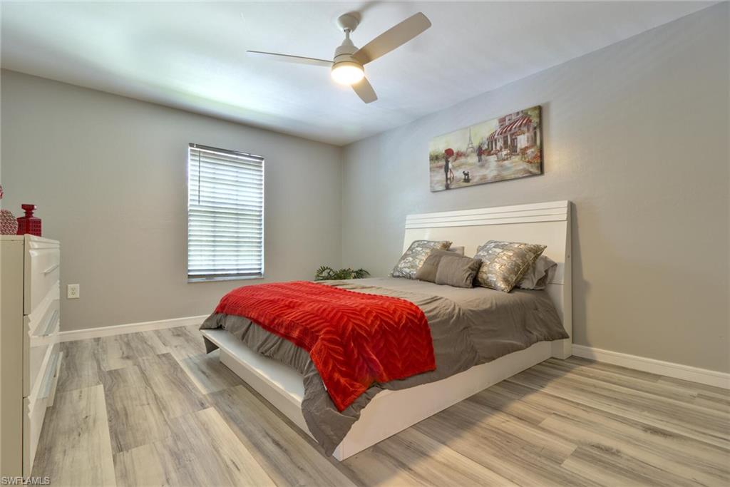Bedroom with light hardwood / wood-style flooring and ceiling fan