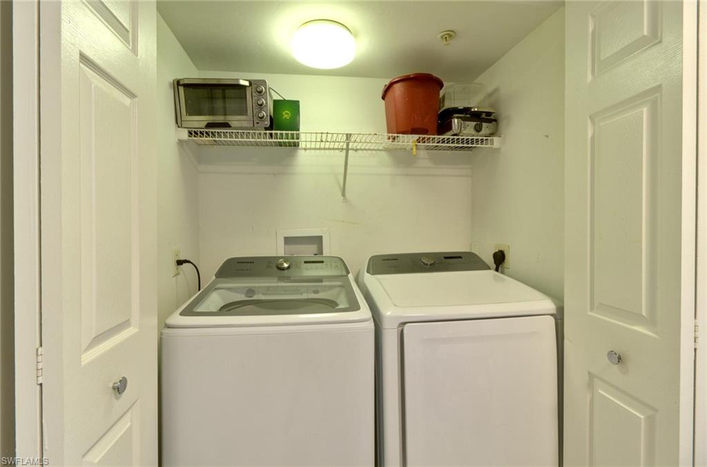Washroom with washer and clothes dryer