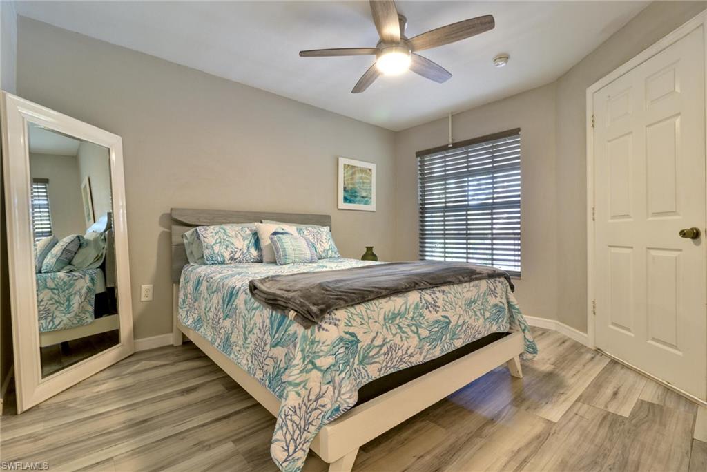 Bedroom with ceiling fan and wood-type flooring