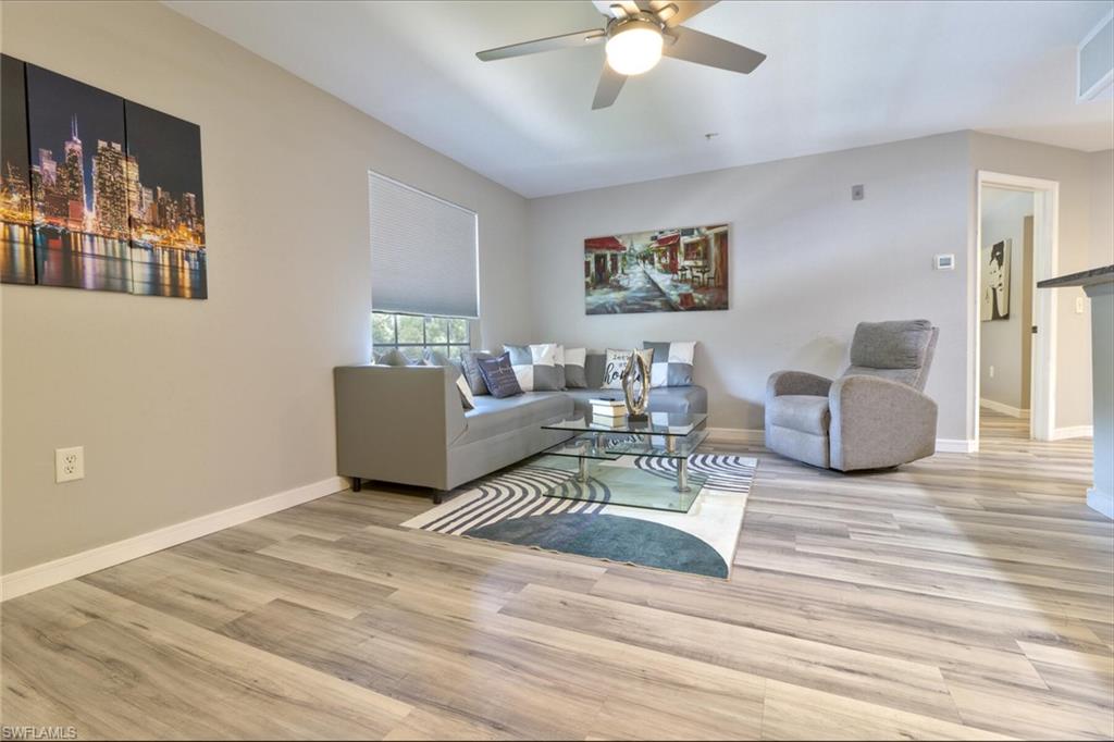 Living room featuring light wood-type flooring and ceiling fan