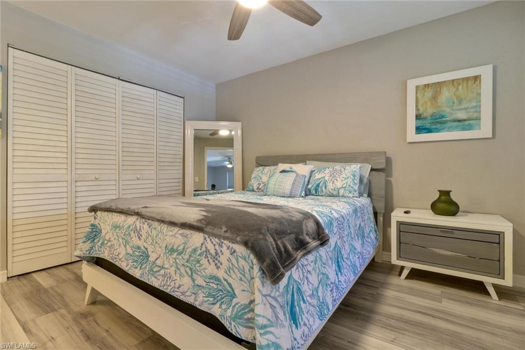 Bedroom with ceiling fan, hardwood / wood-style floors, and a closet