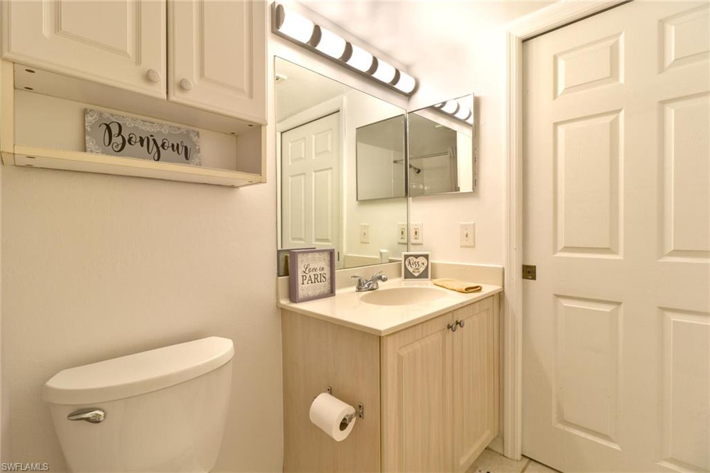 Bathroom featuring vanity, toilet, and tile patterned flooring