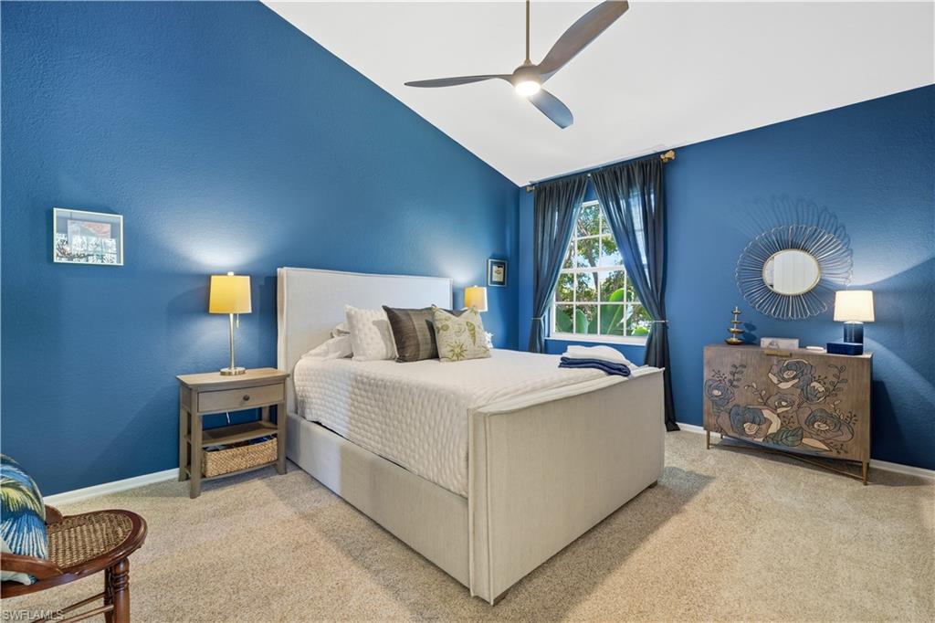 Vaulted ceilings add volume and architectural charm to this bright and inviting guest bedroom.