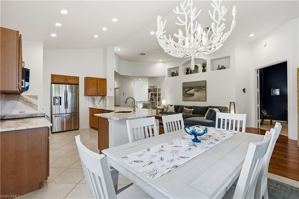 View from the lanai showcasing the open-concept kitchen, dining area, and living room.