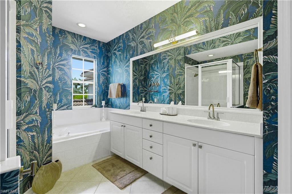 Gorgeous primary ensuite bathroom with dual sinks and custom wallpaper.