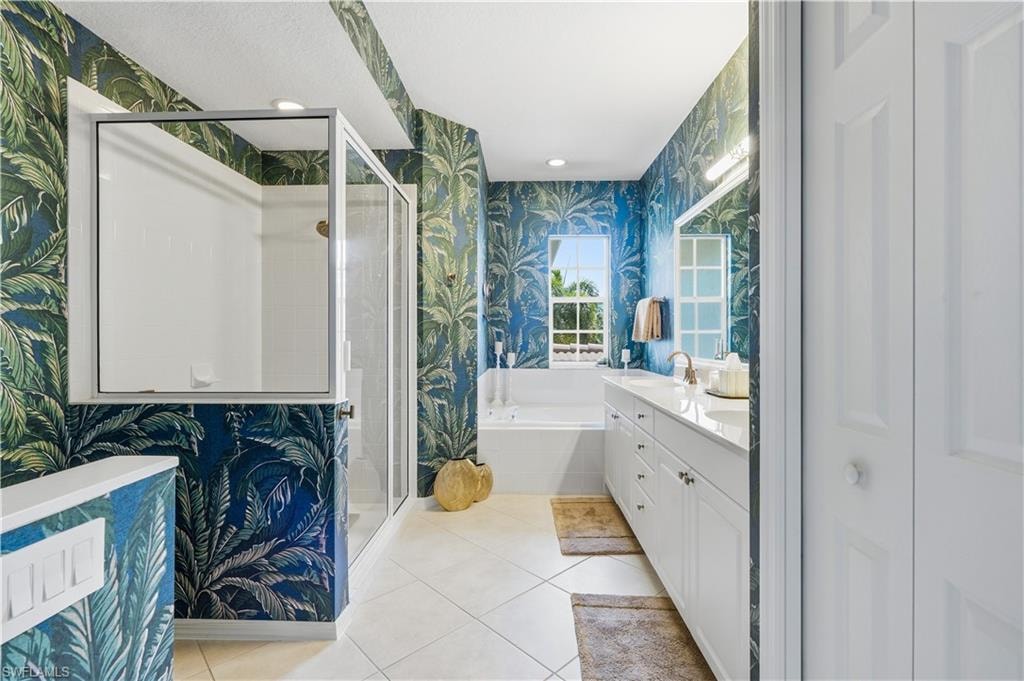 Primary bathroom with large soaking tub and a walk-in shower.