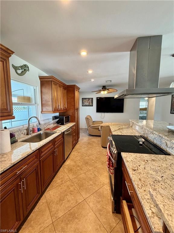 Kitchen featuring granite countertops, wood cabinetry, stainless steel appliances, and tile flooring