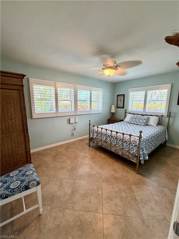 Room featuring large format tile flooring, a ceiling fan with integrated lighting, and three windows equipped with white plantation shutters