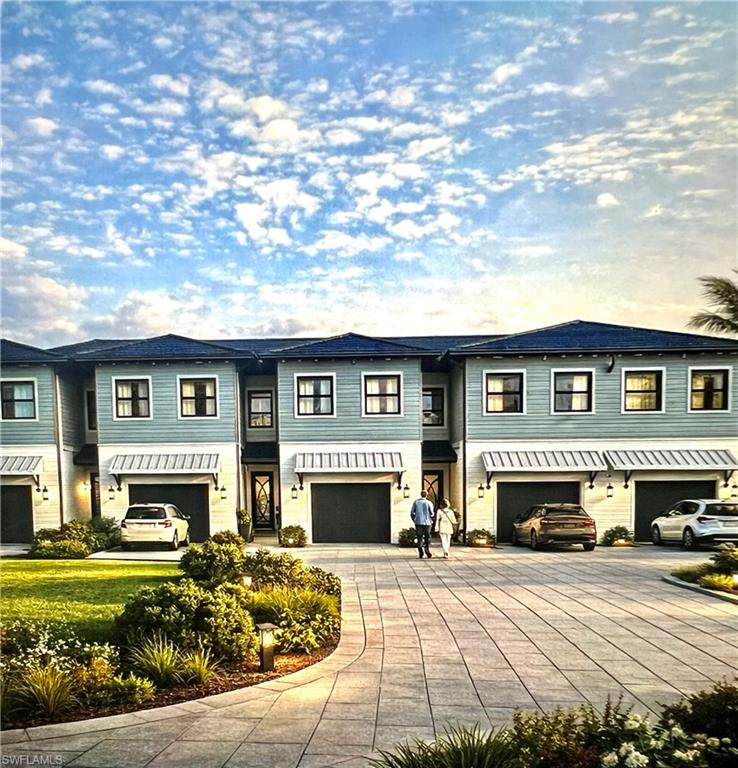 Townhome development featuring light blue siding with dark blue roof accents