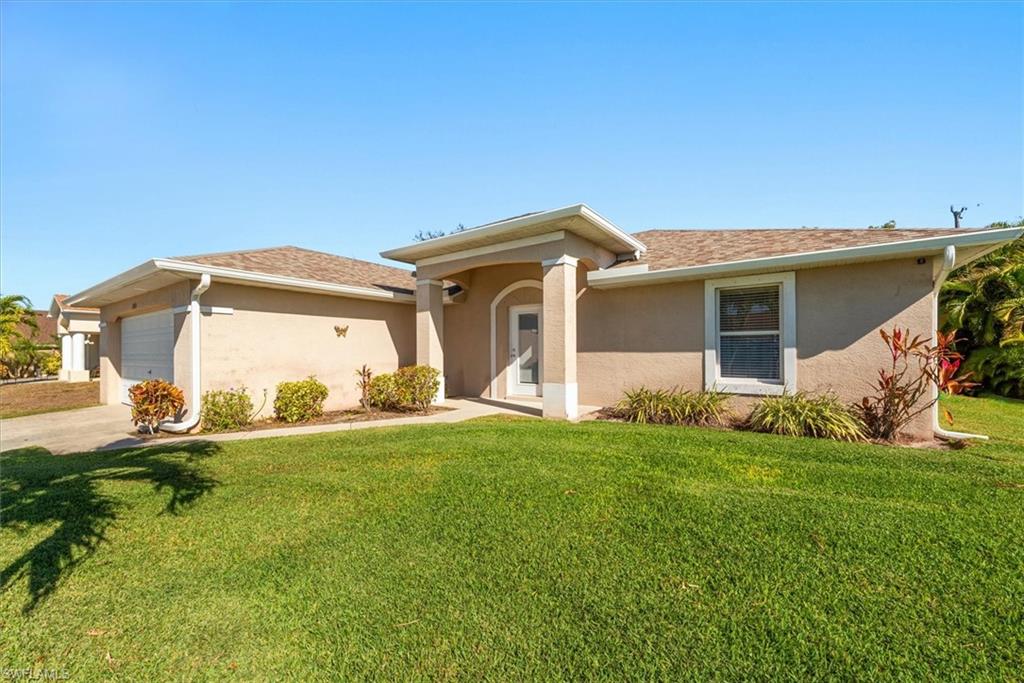 Single-story exterior with stucco finish and a brown shingle roof