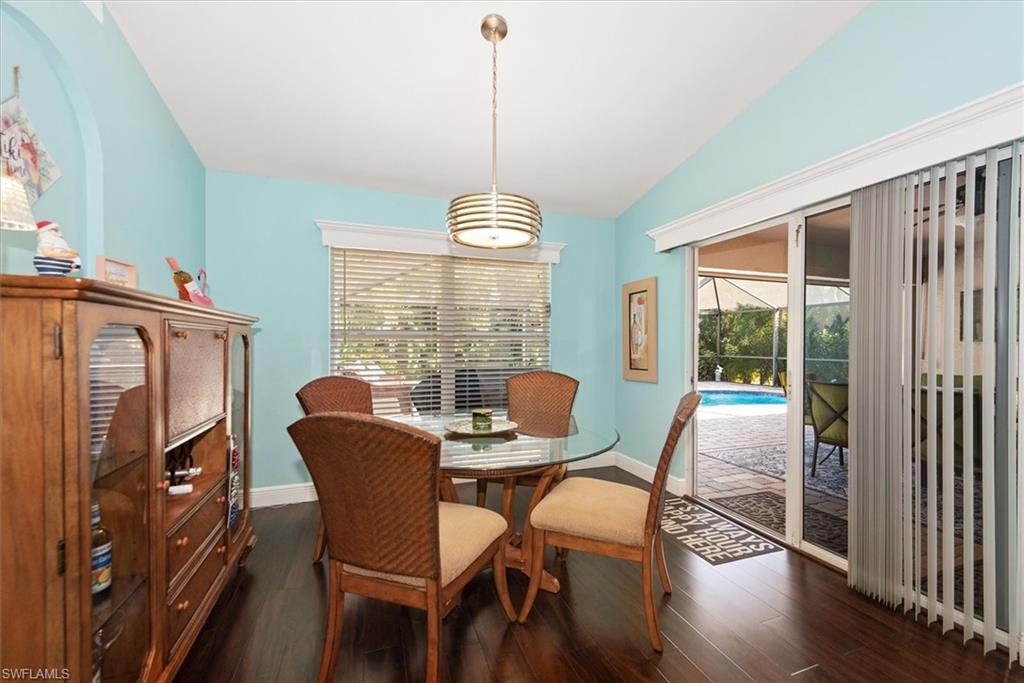 Dining area featuring wood-finish flooring and vaulted ceiling