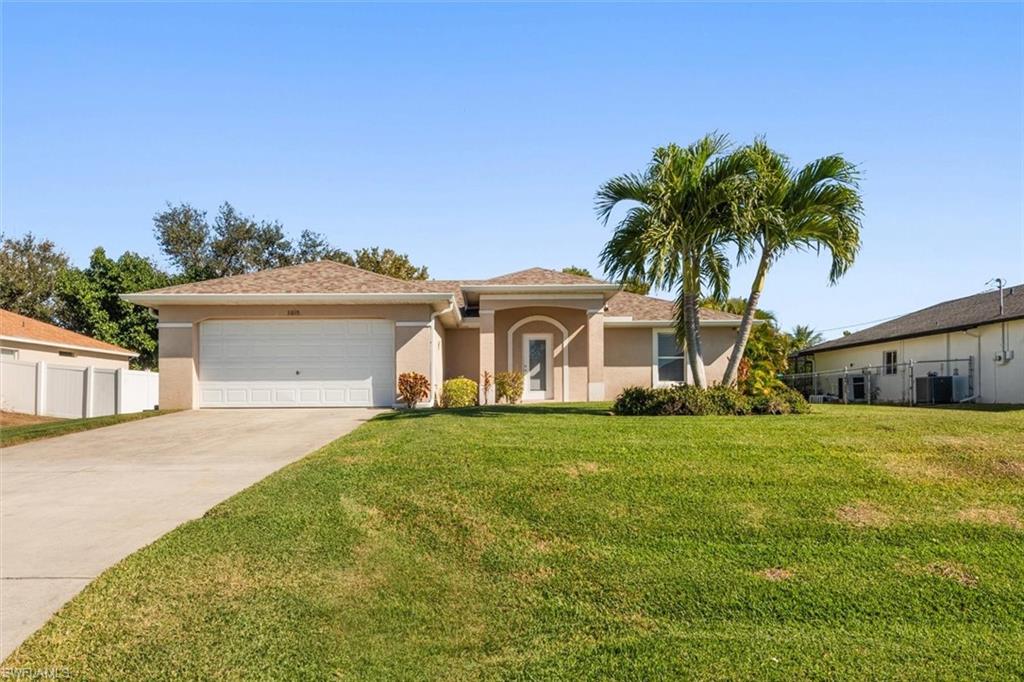 Single-story residence featuring a stucco exterior, attached two-car garage, and a concrete driveway