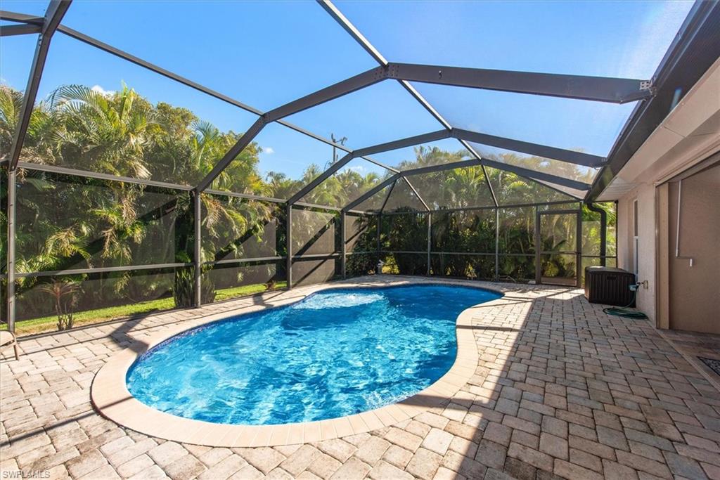 Freeform swimming pool within a screened enclosure