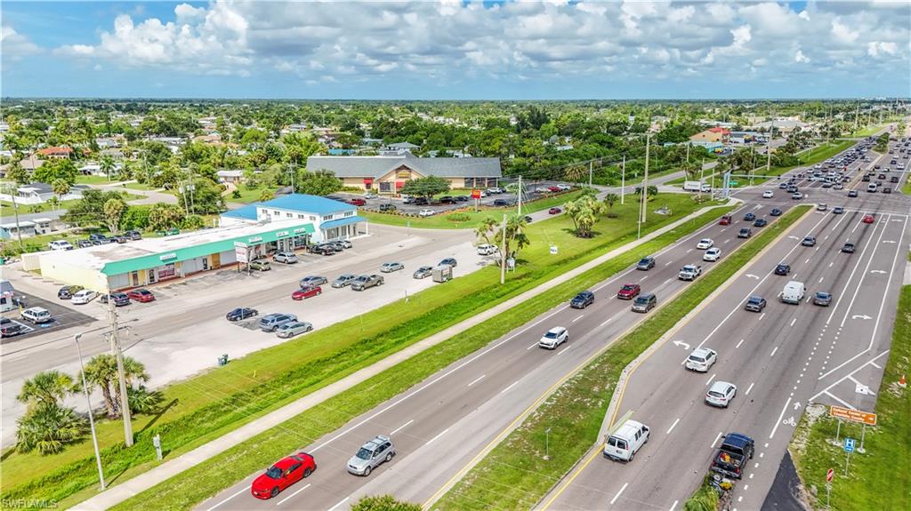 Commercial strip center featuring a blue metal roof and multiple storefronts
