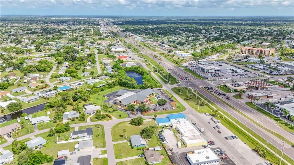 Aerial perspective showcasing a mixed-use community with residential areas and commercial establishments