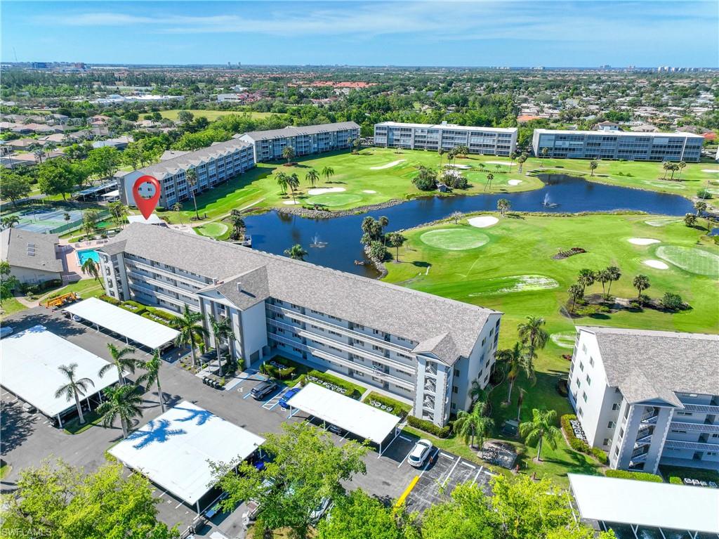 Drone / aerial view of a golf course and a nearby body of water