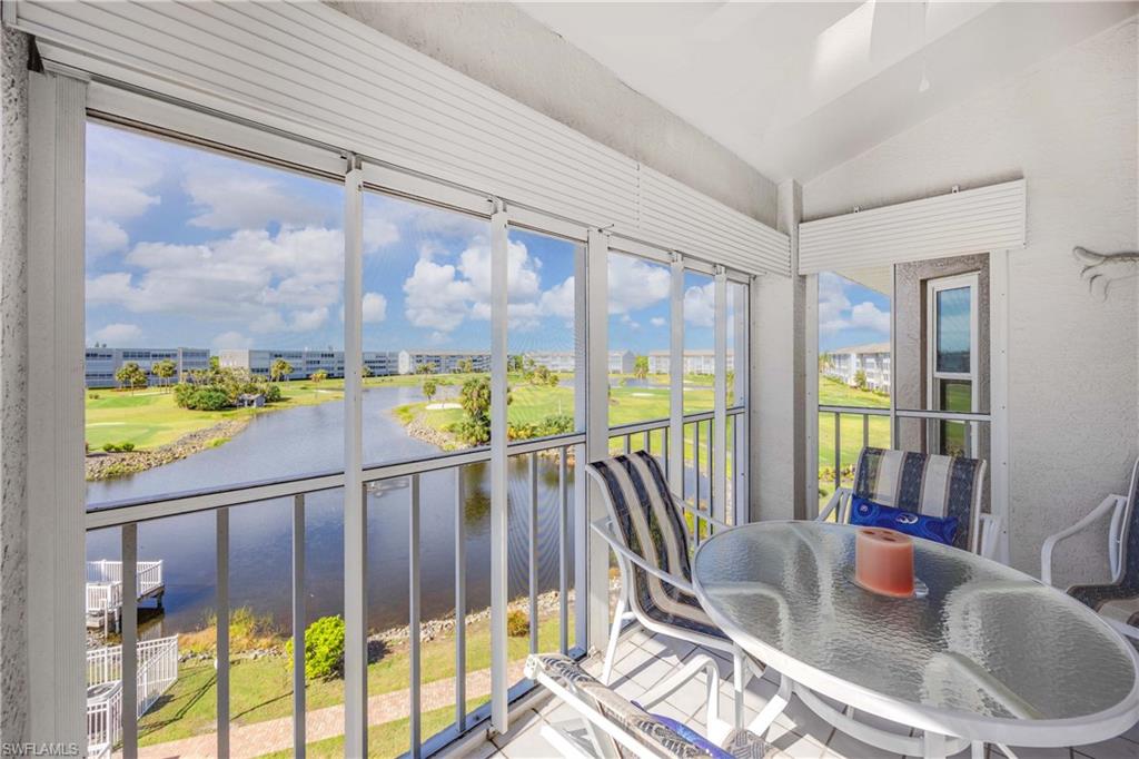 Sunroom / solarium with lofted ceiling and a water view