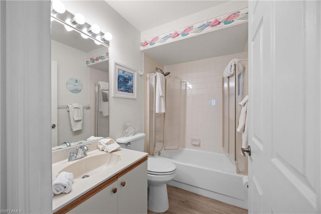 Full bathroom featuring vanity, light wood-style flooring, and shower / washtub combination