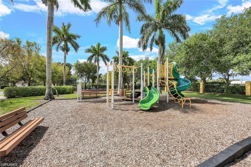 Outdoor recreational area featuring a playground structure with slides and monkey bars