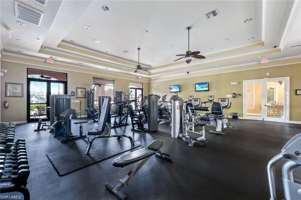 Fitness room featuring rubber flooring, recessed lighting, and multiple exercise machines
