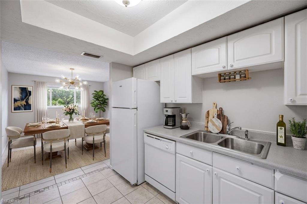 Virtually staged photo showing kitchen out to dining area.
