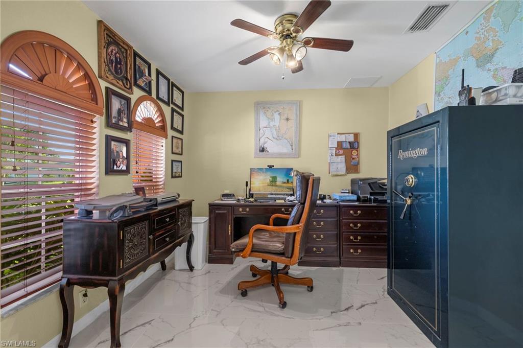 Interior room featuring white-finish flooring, light yellow walls, and a ceiling fan with integrated lighting