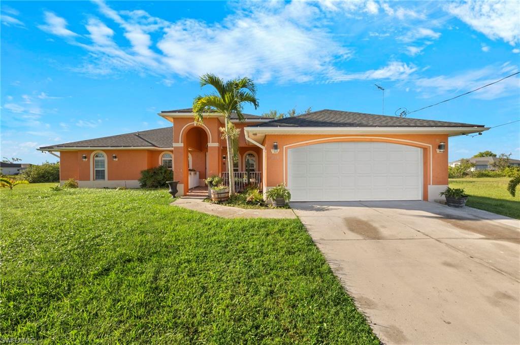 Stucco exterior with a two-car garage and a paved driveway