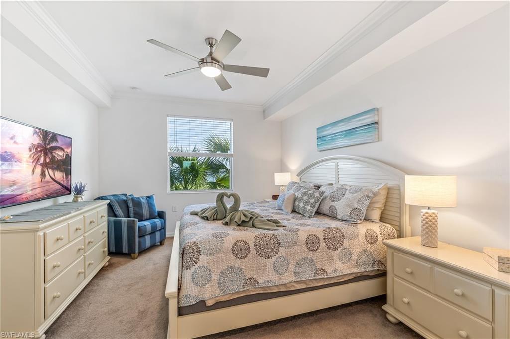Bedroom featuring ceiling fan, carpet floors, and crown molding