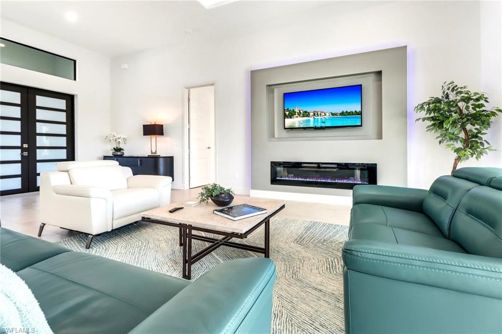 Integrated media wall featuring a recessed television niche and a linear electric fireplace