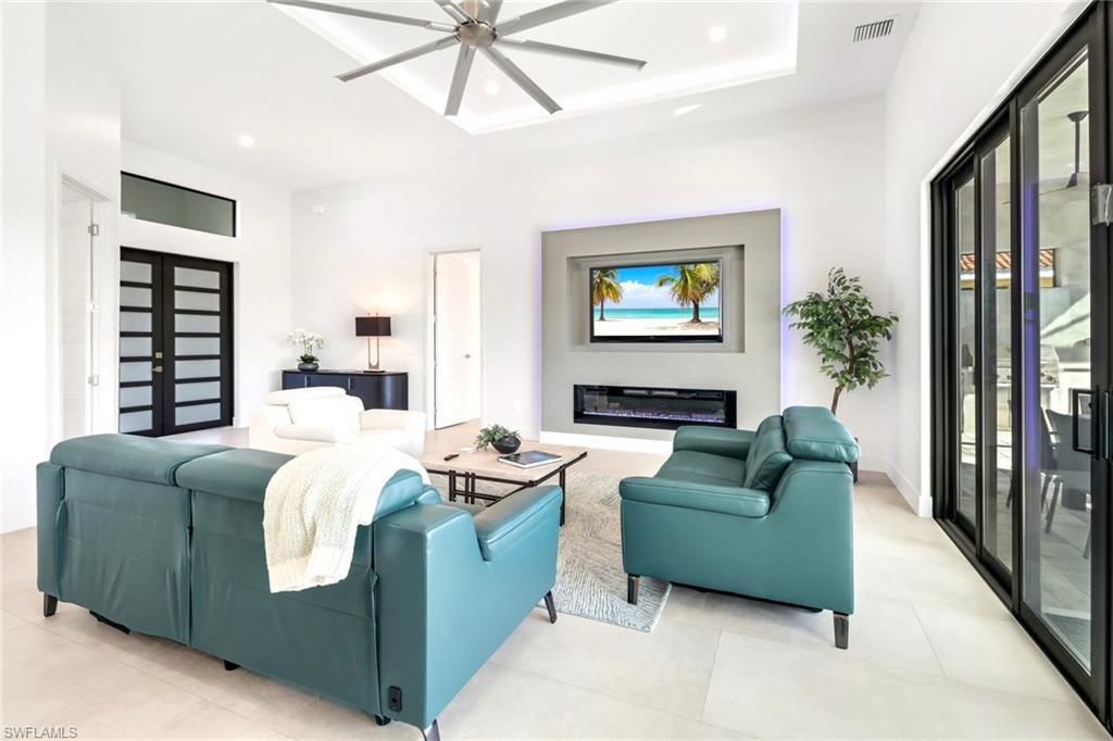 Open concept living area featuring light-toned tile flooring throughout