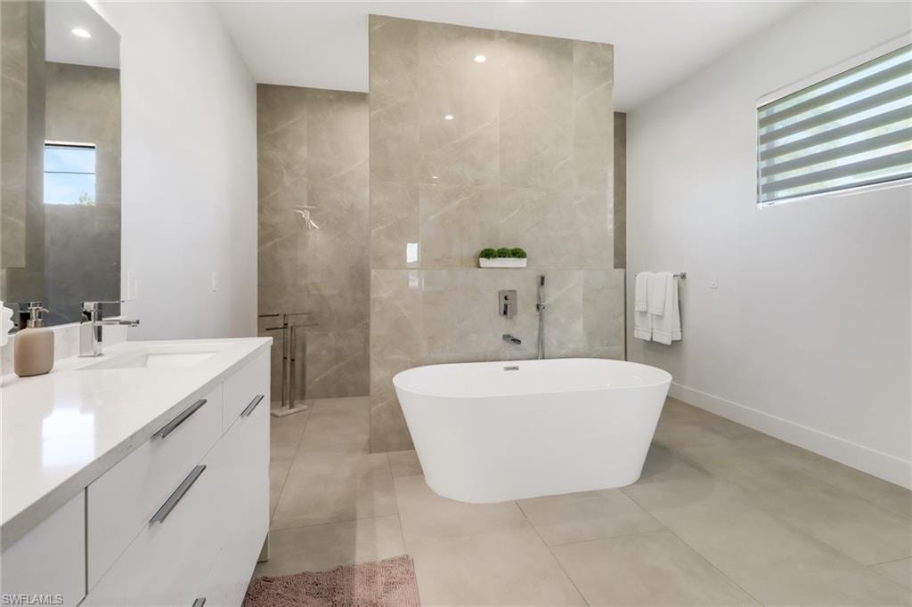 Contemporary bathroom featuring a freestanding soaking tub with wall-mounted fixtures