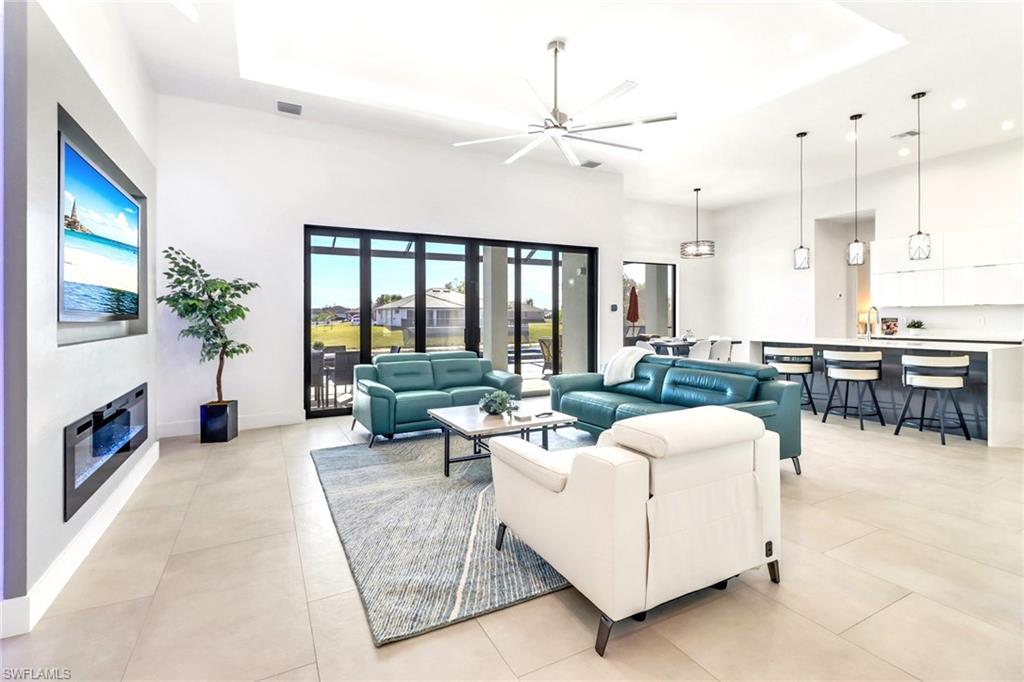 Spacious interior featuring a vaulted ceiling and light-toned tile flooring