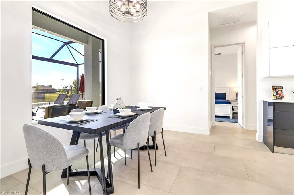 Dining area featuring a large window overlooking a screened patio and water feature