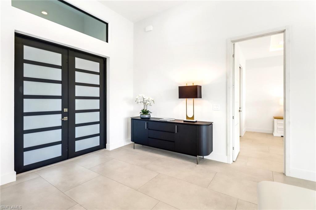 Double-entry doors with frosted glass panels and transom window