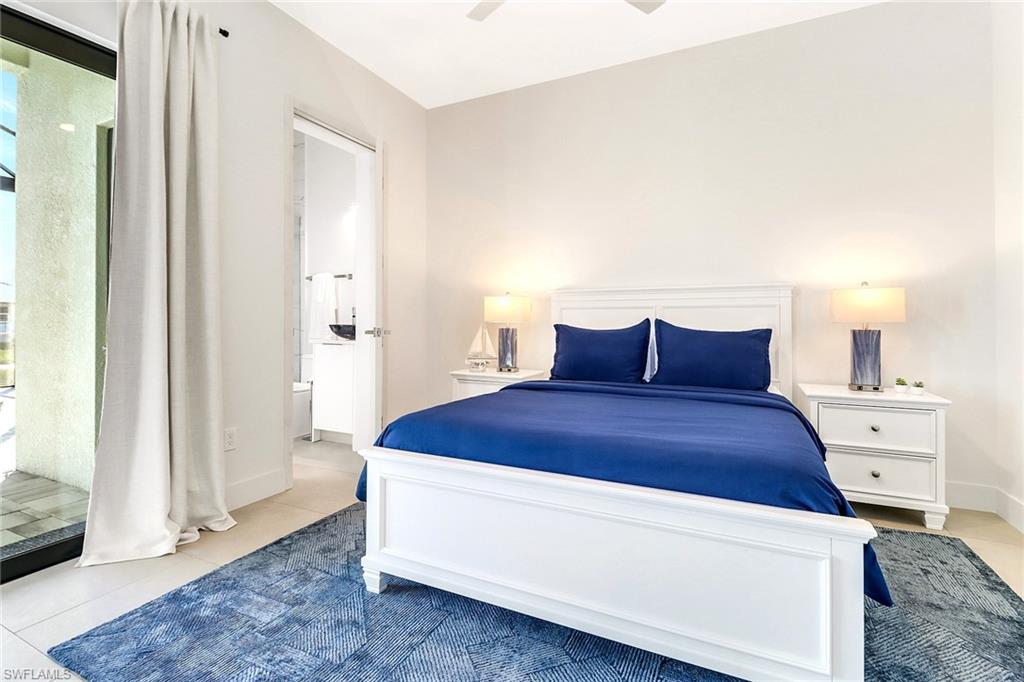 Bright bedroom featuring tile flooring and a sliding glass door