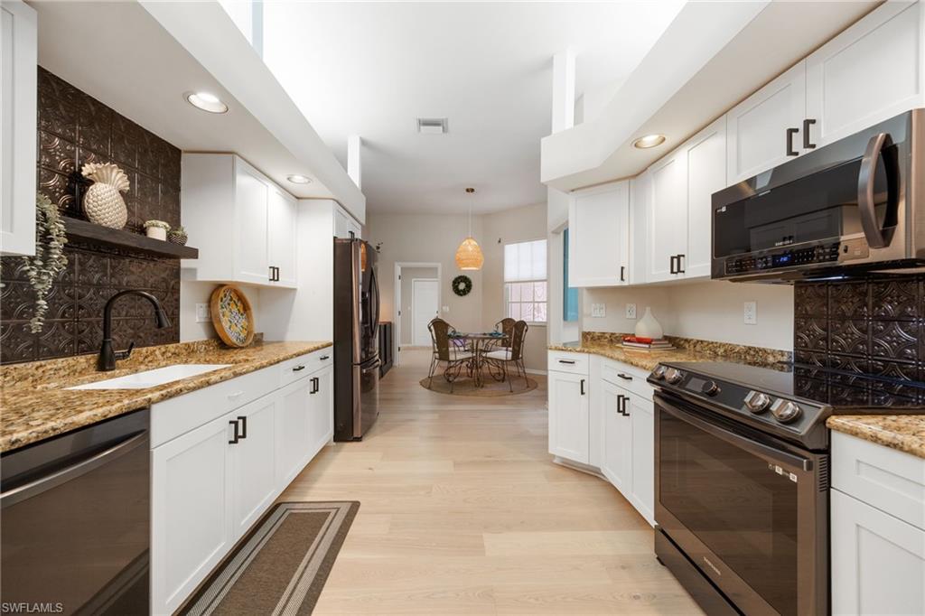 Looking from other side of kitchen - you have a 2nd dining space in the Kitchen - "breakfast area". The far door leads to the laundry room and then to the garage.