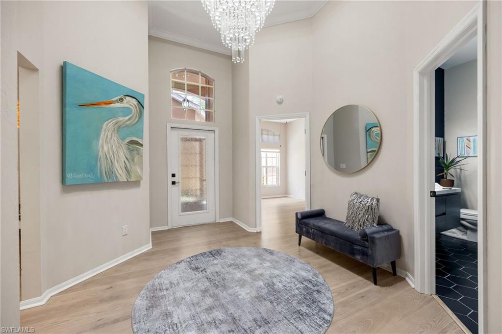 Walk into this grand foyer with tray ceiling, gorgeious crystal chandelier. Home is painted in neutral colors, Engineered Hardwood flooring throughout and tile in bathrooms.