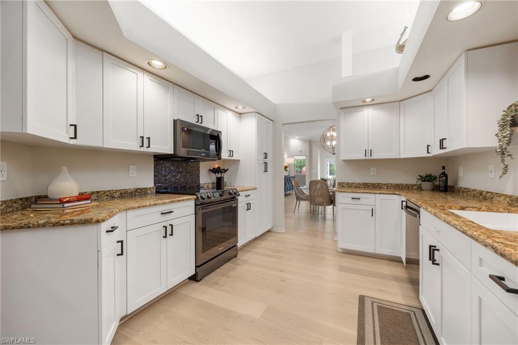 Entering the kitchen from front entrance. Great space, loads of cabinetry - newly face, newer appliances, includes pantry, above and below cabinet lighting.