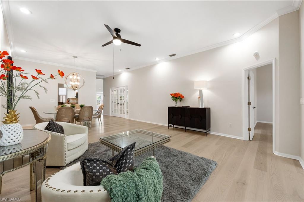 Living Room,Dining Room combo. Door on right leads to Primary Bedroom. Behind the French Glass doors is a great size den/office/guest room.