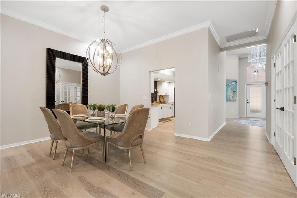 View from Front Entry into home. See full glass front door. From front entrance you can enter into the kitchen on right, 2nd bedroom on left, den with french doors on left and come into the main Dining / Living space.