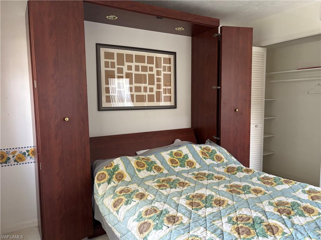 Built-in wall unit featuring a rich wood-finish, integrated lighting, and a coordinating headboard