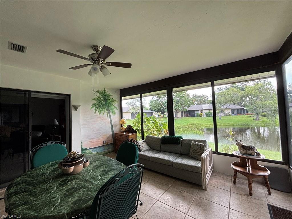 Screened enclosure with ceramic tile flooring and a ceiling fan
