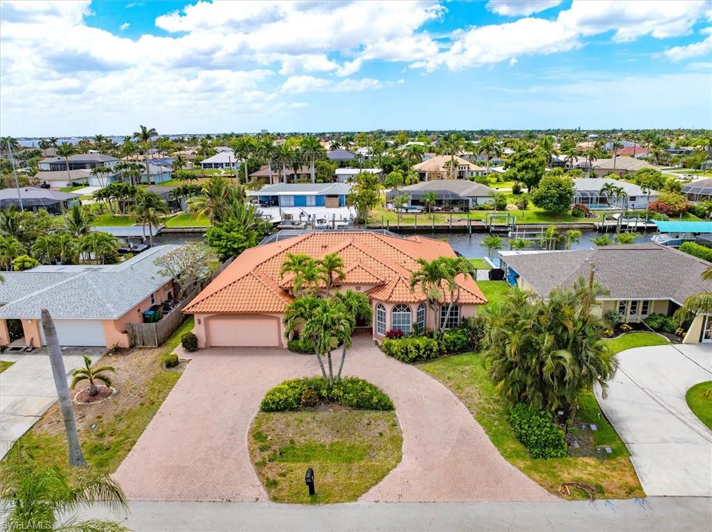 Aerial perspective of suburban area featuring a large body of water