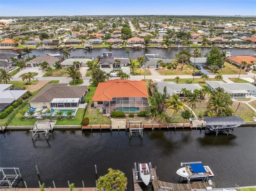 Aerial view of residential area featuring a nearby body of water