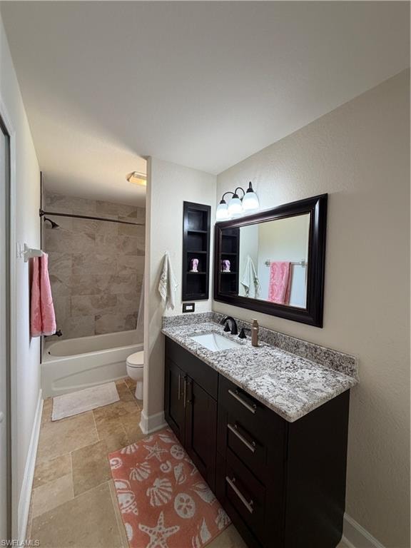 Hallway Bathroom featuring a dark wood vanity with granite  countertop and undermount sink, a framed mirror, and built-in shelving