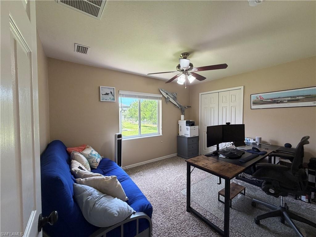 Bedroom 3 with a large window, a ceiling fan with integrated lighting, and bi-fold closet doors