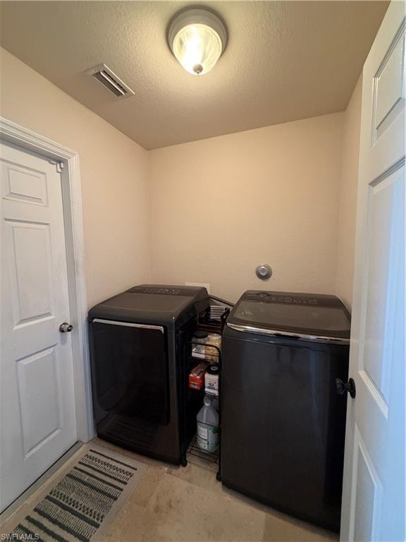 Laundry area featuring light-toned walls, tile-finish flooring, and white paneled doors
