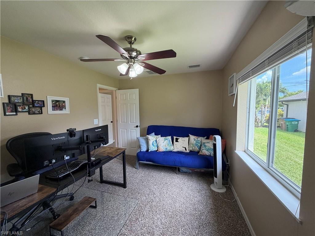 Bedroom 3 featuring a window with horizontal blinds, a ceiling fan with integrated lighting, and neutral wall tones